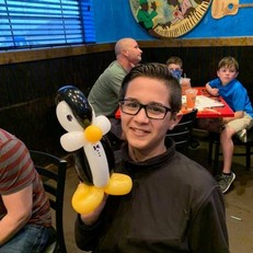 boy with glasses holding penguin.jpg